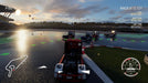 FIA European Truck Racing Championship Gameplay Screenshot (Wet Track) In-game screenshot from FIA European Truck Racing Championship on Xbox One, featuring intense truck racing on a wet track with sunset reflections. Experience high-speed competitive truck racing with realistic weather effects. Buy your game key now at RushGame.co