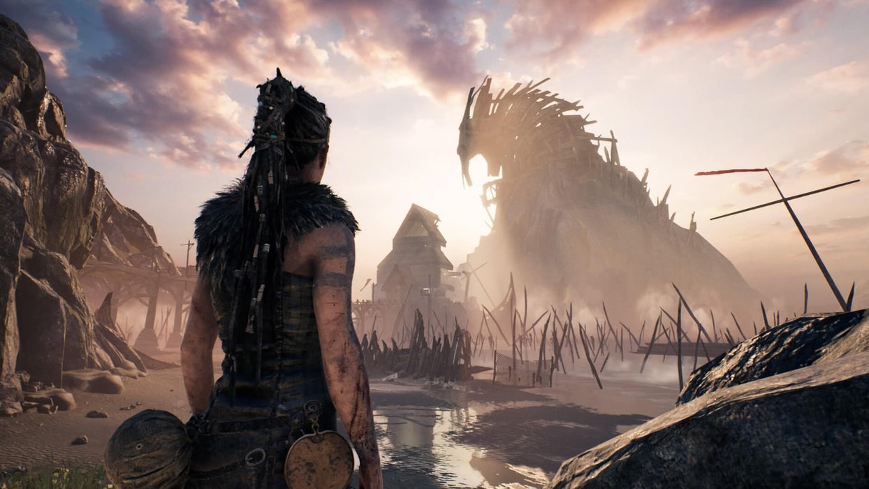 Hellblade: Senua's Sacrifice game screenshot - Senua in a village at sunset