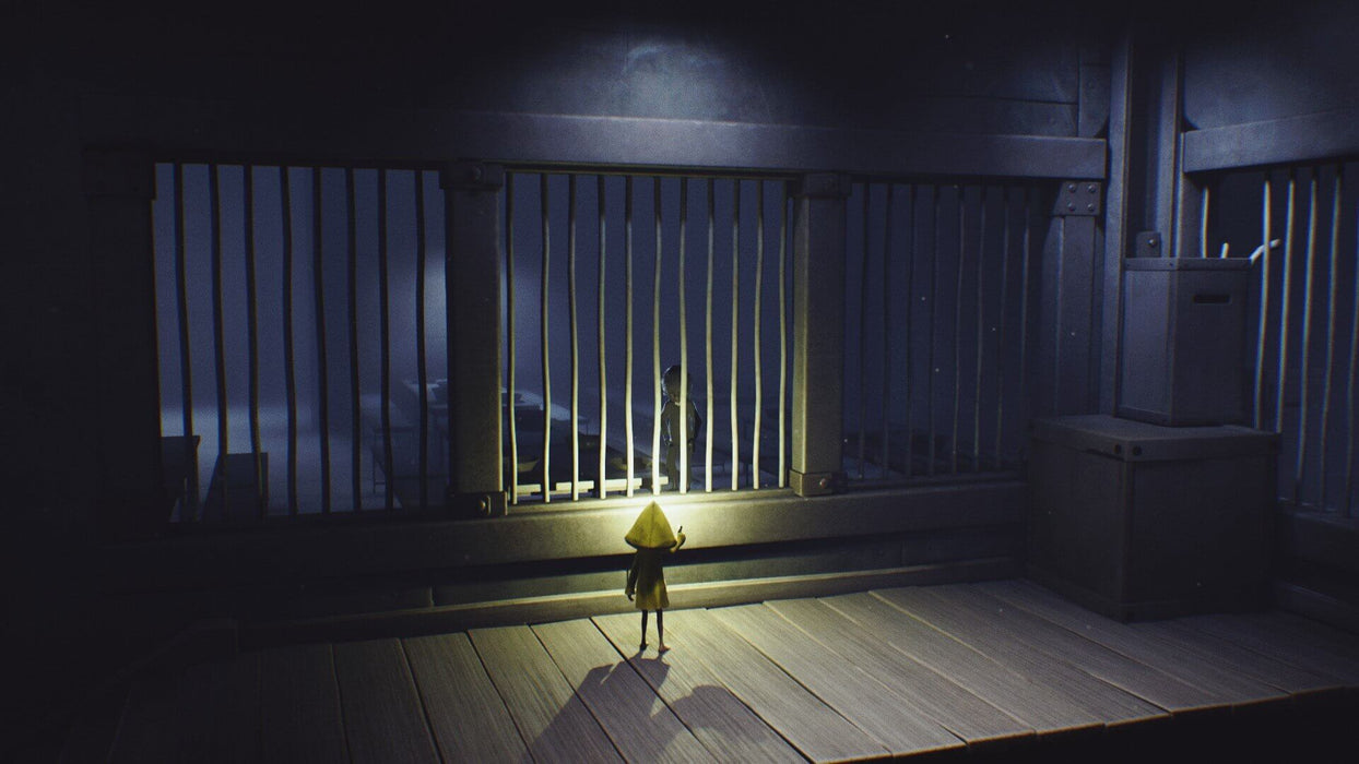 The protagonist in a yellow raincoat stares through metal bars at another mysterious figure during her eerie adventures in the dark and grim world of Little Nightmares Complete Edition xbox one xbox series Key. Get the best prices on xbox Keys at RushGame.co