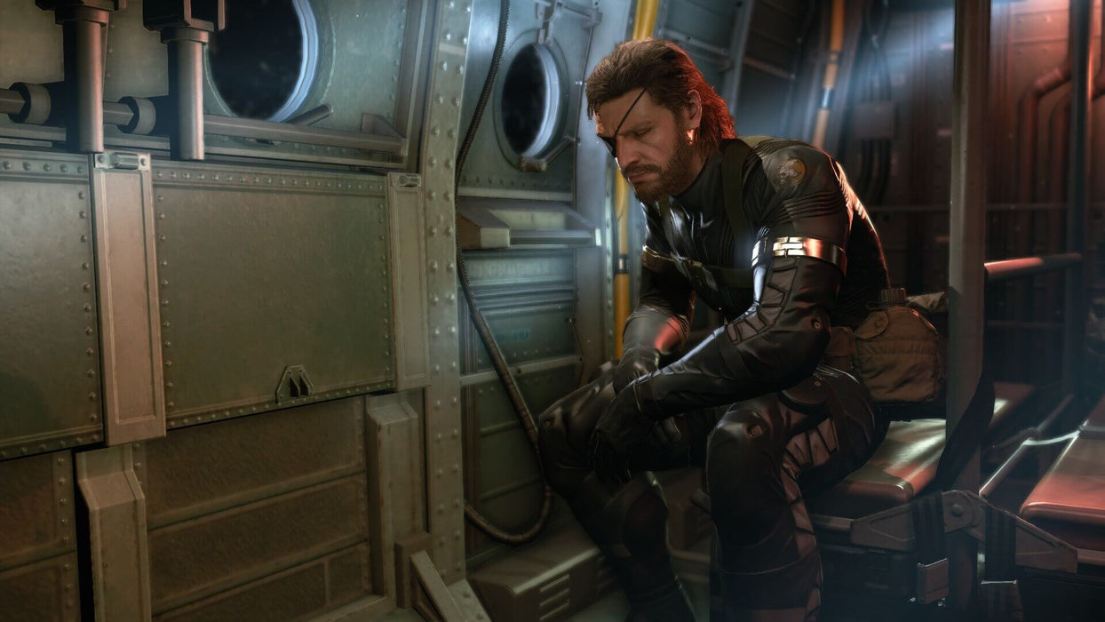 Snake sits solemnly inside a helicopter, deep in thought in Metal Gear Solid V: Ground Zeroes on Xbox One. Buy the game at RushGame.co.