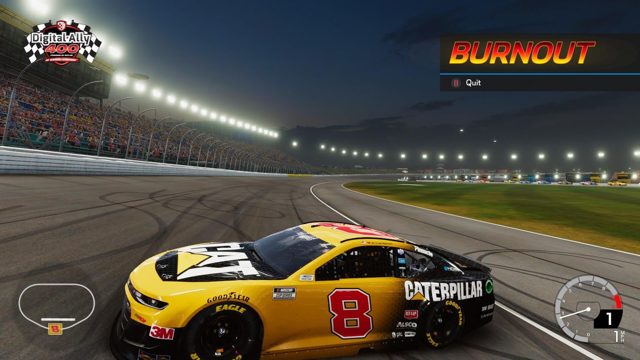 Nighttime victory lap in NASCAR Heat 5 PC Steam – A Caterpillar car doing a victory burnout on a night track after winning a race. The track is lit with stadium lights and the burnout option is highlighted on the screen. Purchase the game at RushGame.co