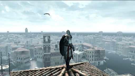 Ezio Auditore stands atop a rooftop in Assassin’s Creed II, overlooking the detailed cityscape of Renaissance Venice. Explore historic cities with enhanced visuals in The Ezio Collection, available at RushGame.co