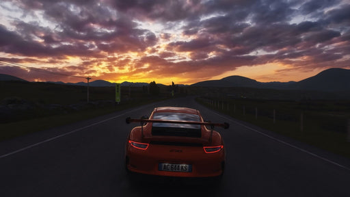 A breathtaking scene with an orange Porsche 911 GT3 RS driving on an open road, illuminated by the golden light of the setting sun. Drive legendary cars in a realistic simulation, available at RushGame.co