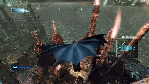 This in-game screenshot from Batman: Arkham City GOTY shows Batman gliding over Gotham's industrial area with his cape spread wide, navigating through the cold night. The atmospheric setting, complete with smokestacks and a temperature gauge, adds to the immersive experience of this legendary action-adventure game. Get your Batman: Arkham City GOTY PC Steam CD Key now at RushGame.co for instant digital delivery