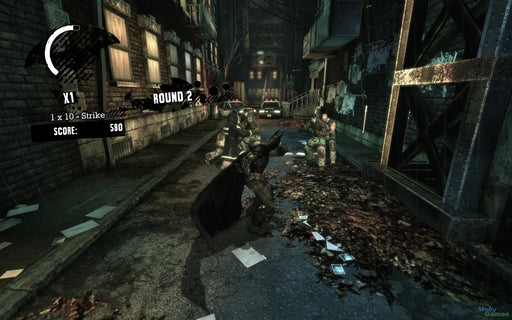 A gameplay screenshot from Batman: Arkham Asylum, showing Batman engaging in a combat sequence against multiple enemies in a dark, rain-soaked alleyway. Experience the iconic FreeFlow combat system—buy your Batman: Arkham Collection Steam Key now at RushGame.co