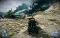  A player-controlled military jeep speeds through a desert battlefield in Battlefield 3. Explosions and black smoke fill the distance, while game HUD elements indicate an ongoing large-scale conflict. Secure your Battlefield 3 Limited Edition PC EA Play Origin CD Key instantly at RushGame.co