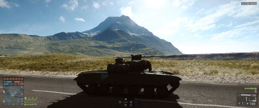"In-game screenshot from Battlefield 4 on Default Title, showing a tank positioned on an open road with a mountain landscape in the background under a clear blue sky
