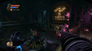 Third Screenshot: "A dark and eerie location in BioShock 2, featuring a drill weapon in the player's hand and a glowing 'Fallen Fallen is Babylon' sign in the background. Purchase BioShock: The Collection for Xbox One at RushGame.co