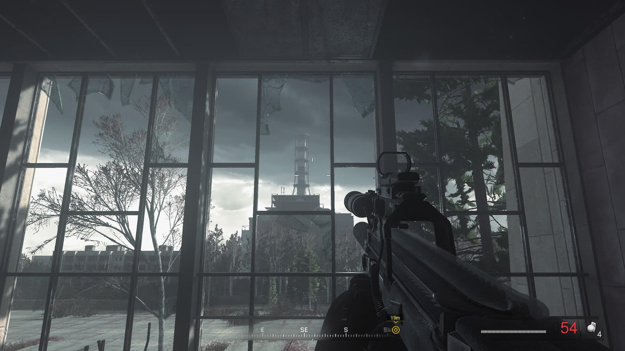 Gameplay Screenshot 
A player aiming a rifle through a shattered window at the abandoned Chernobyl reactor in Call of Duty: Modern Warfare Remastered. Secure your Xbox One CD key at RushGame.co and dive into one of the most immersive missions in FPS history