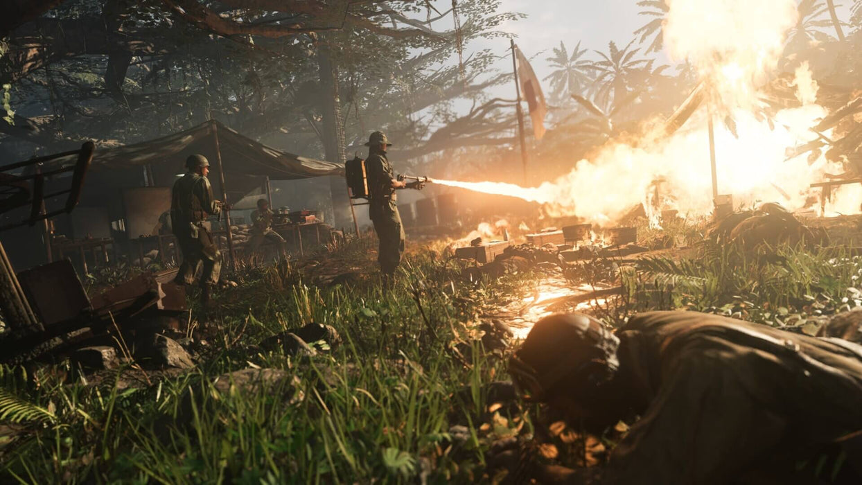 Gameplay Image: A dramatic jungle warfare scene where a soldier is seen using a flamethrower to attack an enemy encampment, with intense fire effects lighting up the battlefield. Secure your Call of Duty: Vanguard Xbox Series X|S key at RushGame.co and fight across historical World War II fronts with dynamic combat