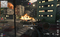 Gameplay Image: A multiplayer battle scene from an urban combat zone, viewed from a high vantage point with a scoped weapon, as explosions engulf buildings and vehicles in flames. Purchase your Call of Duty: Vanguard Xbox Series X|S CD Key US at RushGame.co and dominate in high-action multiplayer and Zombies mode