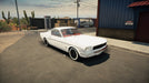 gameplay screenshot: A beautifully restored white classic muscle car in Car Mechanic Simulator 2021 on PC Steam, parked in a small desert town. Experience detailed car restoration—buy your Steam CD key now at RushGame.co!