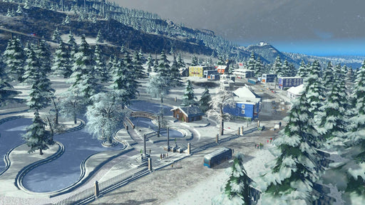 Gameplay screenshot: A winter-themed cityscape from Cities: Skylines - Snowfall DLC, featuring snow-covered trees, roads, and buildings in a picturesque mountainous region. Purchase the Cities: Skylines - Snowfall DLC PC key at RushGame.co and experience new challenges in city management with snowy weather conditions