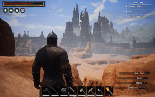 Gameplay screenshot from Conan Exiles on PC, showing a heavily armored warrior gazing at an ancient ruined fortress in a vast desert landscape. The UI displays the player's health, stamina, and inventory, emphasizing the game's survival mechanics. Get your Conan Exiles CD key at RushGame.co for instant digital access