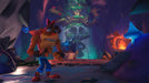 Crash Bandicoot 4: It's About Time Screenshot – Mysterious Cave Level – A gameplay scene from Crash Bandicoot 4: It's About Time, showcasing Crash Bandicoot in a dark, glowing cave filled with tribal decorations, floating blue mushrooms, and a foreboding skull-shaped structure. The vibrant lighting adds depth to the mystical setting. Buy the Xbox digital key at RushGame.co