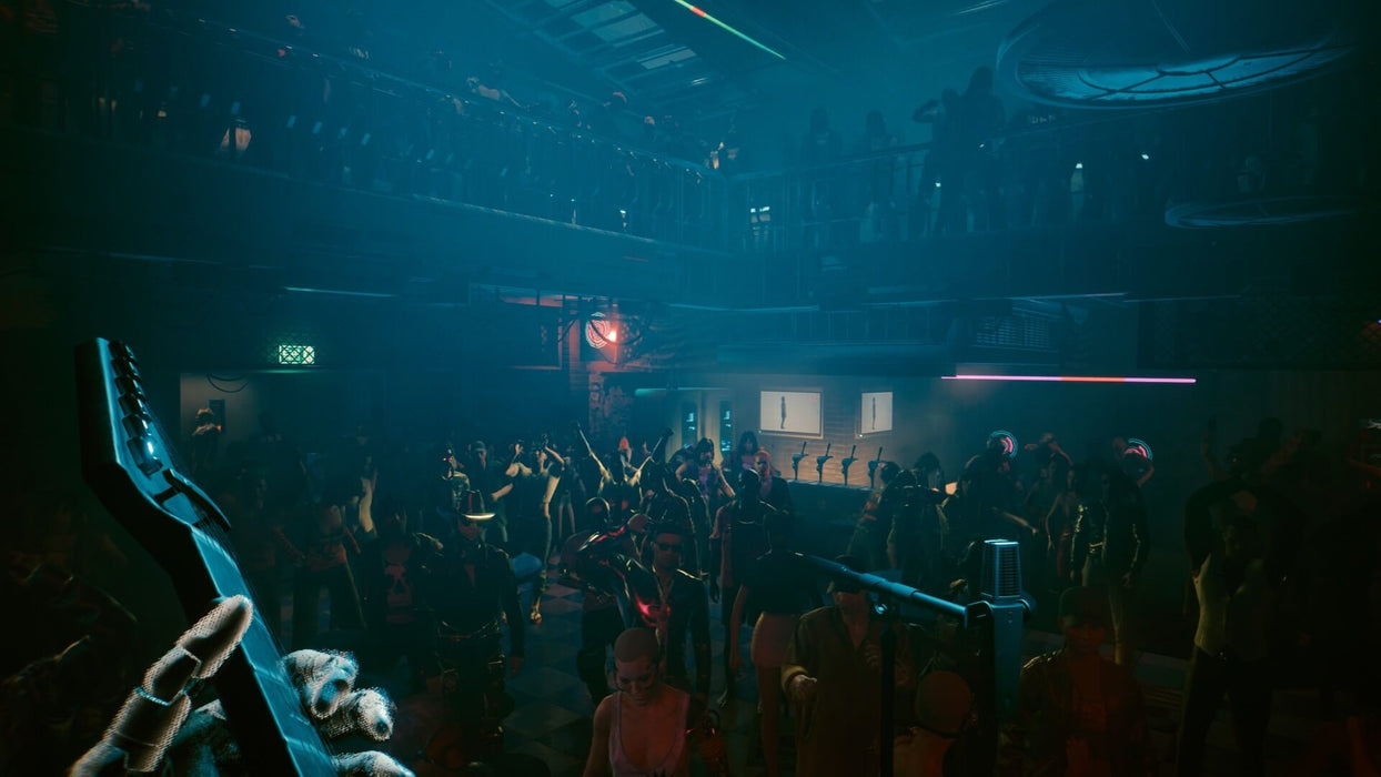 Cyberpunk 2077 PC GOG CD Key - Screenshot 4 – A dynamic concert scene inside a cyberpunk nightclub, viewed from the perspective of a guitarist on stage. The crowd is immersed in the music, dancing under neon lights. Experience the immersive world of Cyberpunk 2077—buy your game key now at RushGame.co