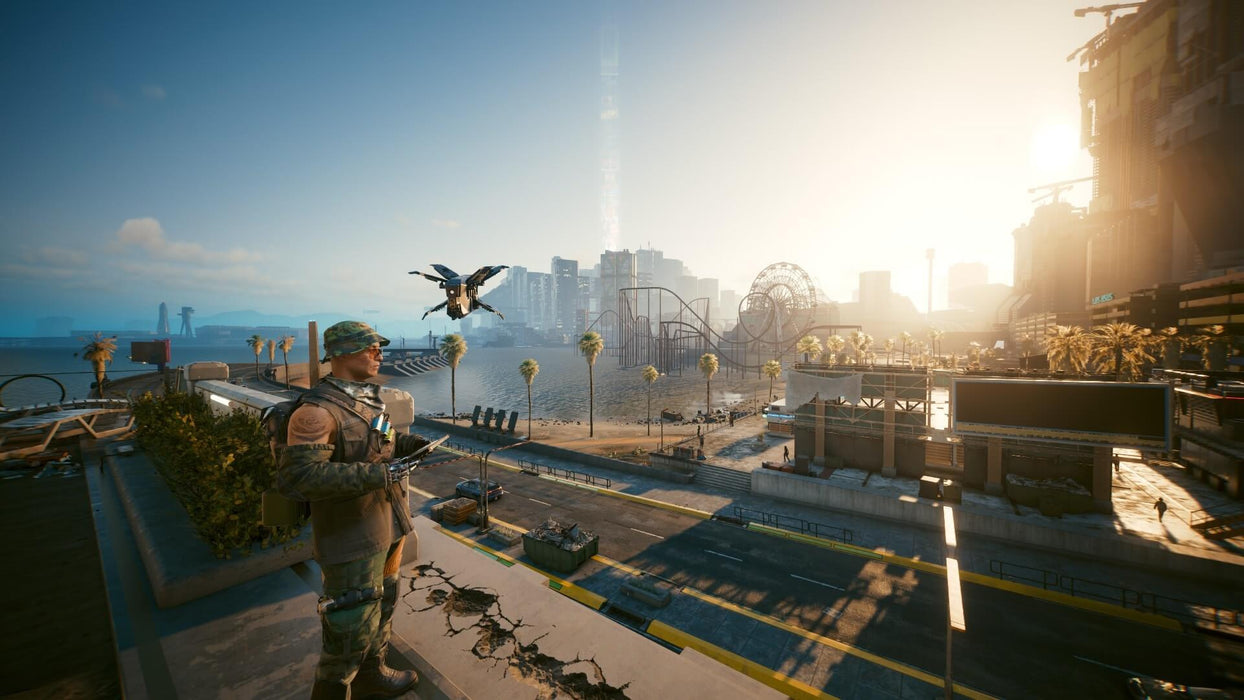 Cyberpunk 2077: Coastal View with Drone gameplay screenshot – A soldier observes the coastline of Night City in Cyberpunk 2077: Phantom Liberty, with a hovering surveillance drone beside him. The futuristic cityscape, complete with high-rise buildings and an amusement park, adds depth to the cyberpunk setting. Get your Cyberpunk 2077: Phantom Liberty DLC Key now at RushGame.co