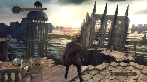 gameplay screenshot: A lone warrior stands atop ancient ruins in Dark Souls II: Scholar of the First Sin, gazing at a hauntingly beautiful ocean horizon. Experience this enhanced edition on PC Steam—buy your game key now at RushGame.co