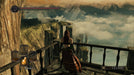gameplay screenshot: A mysterious hooded figure stands on a high balcony overlooking a breathtaking landscape of floating rock formations in Dark Souls II: Scholar of the First Sin. Secure your Steam CD Key today at RushGame.co and test your skills in this punishing RPG