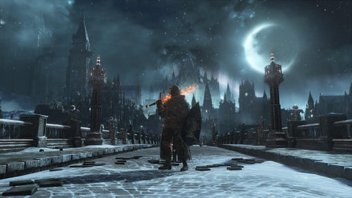 Gameplay screenshot: A lone warrior stands on a snow-covered bridge, wielding a flaming sword, with a gothic castle illuminated by moonlight in the background. Enter the dark world of Lothric—get your Dark Souls III Steam CD Key now at RushGame.co!