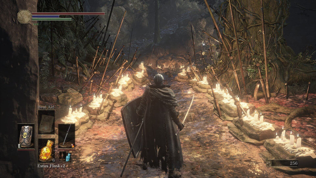 Dark Souls III - Player Facing a Firelit Path: A heavily armored warrior walks down a candlelit path surrounded by swords embedded in the ground, creating an eerie yet majestic atmosphere in Dark Souls III. Get your Dark Souls III CD Key now at RushGame.co