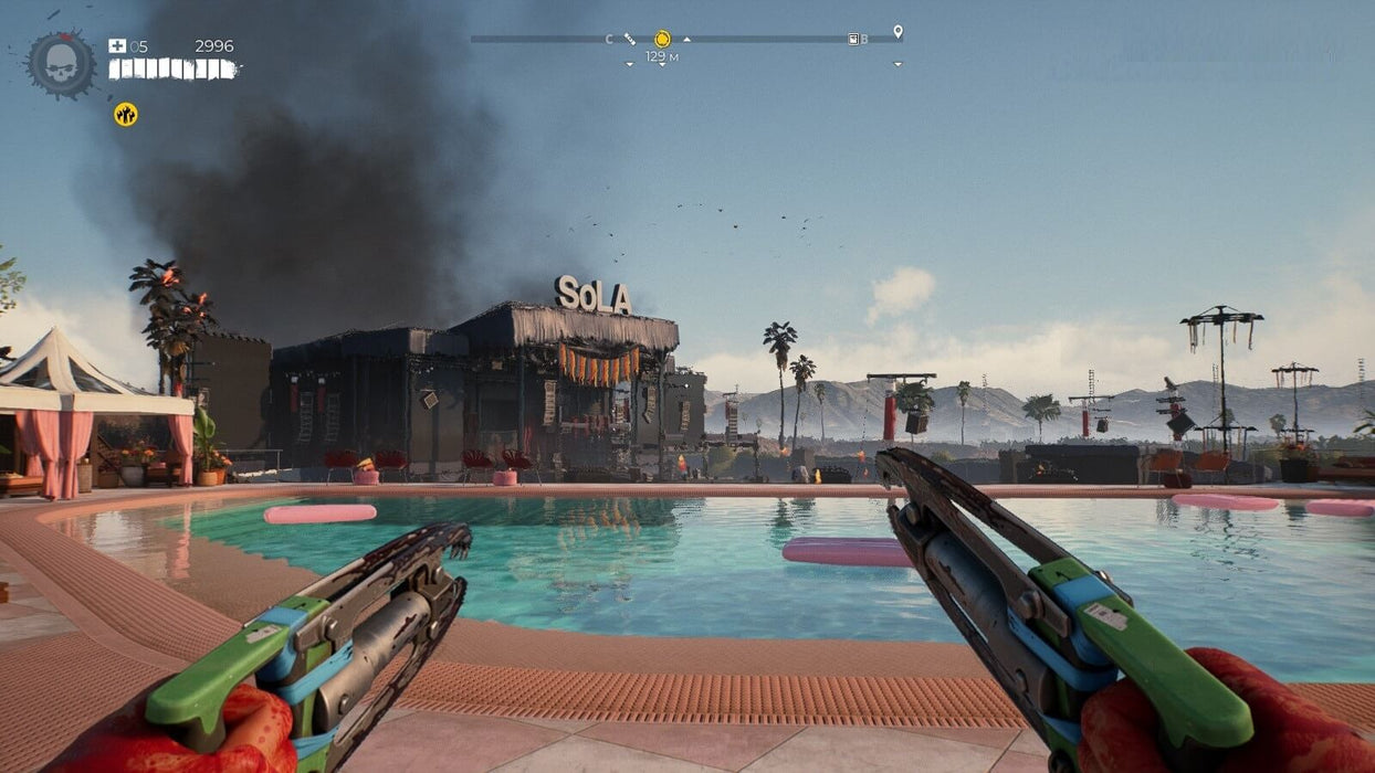 Dead Island 2 gameplay screenshot – luxurious poolside combat – A player wields dual melee weapons near a swimming pool, with a smoky building in the background, showcasing the game's apocalyptic setting in sunny California. Get Dead Island 2 for Xbox One & Series X|S at RushGame.co