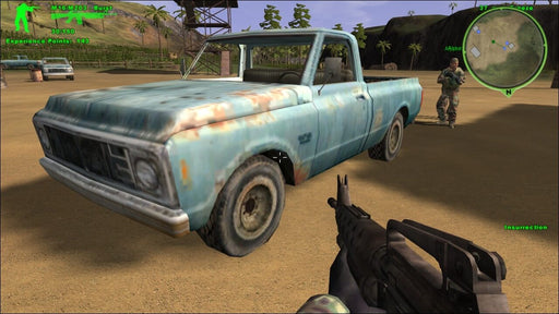 An in-game screenshot from Delta Force: Xtreme displaying a rusted pickup truck in a tropical warzone. The first-person shooter interface shows a military-grade rifle and mission objectives. Tactical squad gameplay with open-world exploration. Get your Steam key instantly on RushGame.co