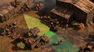 A tactical gameplay screenshot from Desperados III on PC, showing an enemy’s vision cones in green and red. The player-controlled character hides near a water well while two enemies patrol nearby. Wooden barrels and crates create environmental cover. Secure your digital copy now at RushGame.co