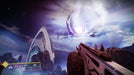 gameplay screenshot - A Guardian in Destiny 2 gazes at a massive glowing portal in the sky, standing near a sleek futuristic building. The landscape is rugged, with jagged rock formations and cloudy skies. Buy Destiny 2 expansions at RushGame.co