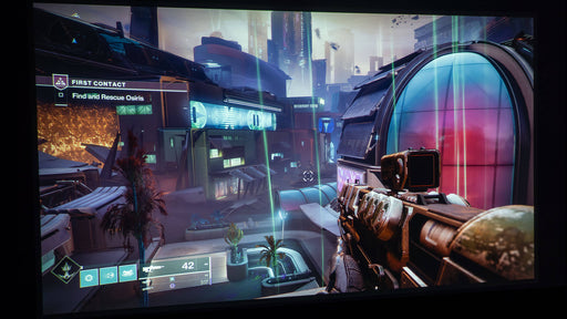 A first-person combat scene from Destiny 2: Lightfall, showcasing a Guardian aiming a futuristic firearm in the mission “First Contact.” The high-tech cityscape is bathed in vibrant lighting effects, emphasizing the sci-fi setting of Neomuna. Experience the new expansion with a Steam CD key from RushGame.co