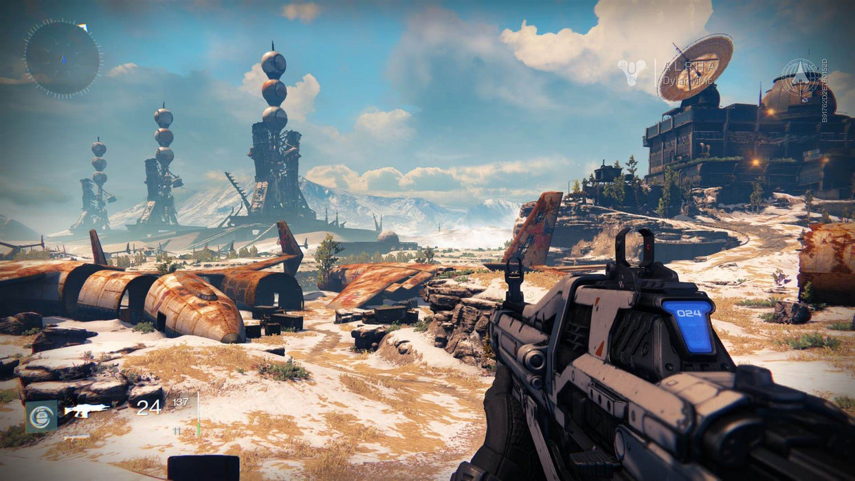 Gameplay screenshot: A scenic view of an abandoned futuristic landscape in Destiny: The Collection on Xbox One. The player holds a futuristic assault rifle while exploring a desolate, rusted battleground under a bright blue sky. Get your digital game key at RushGame.co