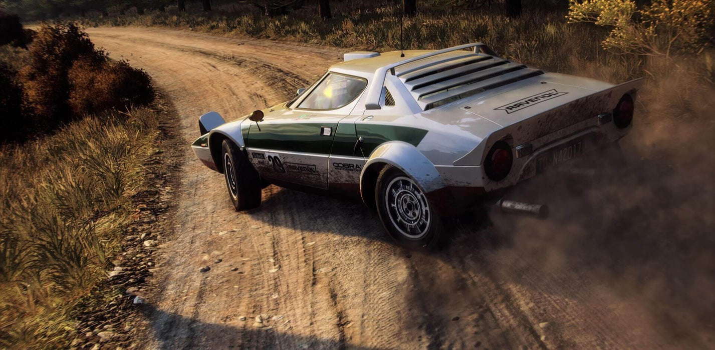gameplay screenshot - A vintage Lancia Stratos kicking up dust as it drifts through a winding rally track in DiRT Rally 2.0, capturing the thrill of off-road racing. Buy your DiRT Rally 2.0 Xbox key instantly at RushGame.co