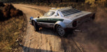 gameplay screenshot - A vintage Lancia Stratos kicking up dust as it drifts through a winding rally track in DiRT Rally 2.0, capturing the thrill of off-road racing. Buy your DiRT Rally 2.0 Xbox key instantly at RushGame.co