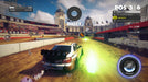 DiRT Showdown gameplay scene with a rally car drifting on a dirt track, activating a boost power-up. The urban stadium setting with grandstands and decorative banners highlights the arcade racing style. Available now at RushGame.co