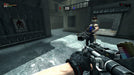 screenshot – multiplayer battle in an urban setting):
"Multiplayer combat in Duke Nukem Forever on PC Steam, featuring an opponent wearing a crown and wielding a heavy weapon while the player aims a futuristic gun in an industrial courtyard. Secure your game key today at RushGame.co