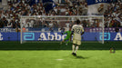 Game screenshot - A penalty kick moment in EA SPORTS FC 24, with Real Madrid’s Eduardo Camavinga preparing to shoot. The crowd, banners, and goalkeeper animations bring realism to the game. Get your EA Play CD Key for PC now at RushGame.co