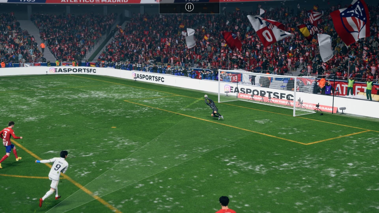 Gameplay scene from EA Sports FC 24 Ultimate Edition on Default Title & Xbox Series X/S, featuring a snowy match between Atlético Madrid and Real Madrid. A player in a white jersey takes a shot on goal as the goalkeeper dives to save. Buy EA Sports FC 24 Ultimate Edition for Xbox at RushGame.co and experience next-gen football realism