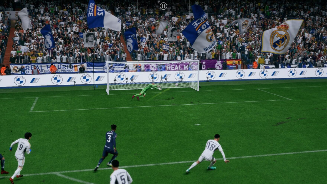 In-game moment from EA Sports FC 24 Ultimate Edition on Default Title & Xbox Series X/S, featuring a powerful shot from a Real Madrid player in a UEFA Champions League match. The goalkeeper dives in an attempt to stop the ball, while the crowd waves white and blue flags in support. Get your EA Sports FC 24 Ultimate Edition CD Key at RushGame.co for instant play