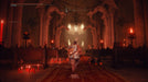 Game screenshot - A warrior charges into a gothic cathedral engulfed in eerie red candlelight in Elden Ring: Shadow of the Erdtree Deluxe Edition for Default Title & Default Title. The intricate architecture and haunting atmosphere hint at a formidable encounter. Get your Elden Ring DLC key instantly at RushGame.co