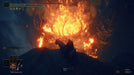 Gameplay Screenshot - A breathtaking nighttime scene from Elden Ring: Shadow of the Erdtree DLC on Steam, showing a lone rider on a spectral steed gazing at a massive burning tree with twisted branches engulfed in flames. Purchase your game key today at RushGame.co