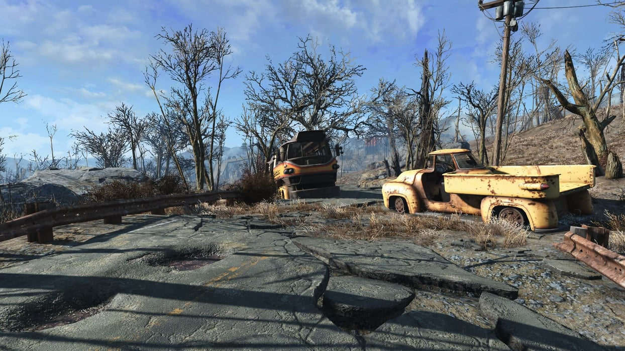 In game screenshot - A cracked road in Fallout 4 leads to abandoned, rusted vehicles with barren trees and a desolate landscape in the background. Experience the open-world adventure of Fallout 4 Xbox One CD Key US, available instantly at RushGame.co