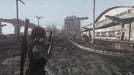 Gameplay screenshot - A lone survivor in Fallout: New Vegas explores a desolate, ruined cityscape near a burned-down supermarket, surrounded by collapsed highways and destruction. Survive, fight, and shape your destiny with Fallout: New Vegas Ultimate Edition PC Steam CD Key, available now at RushGame.co