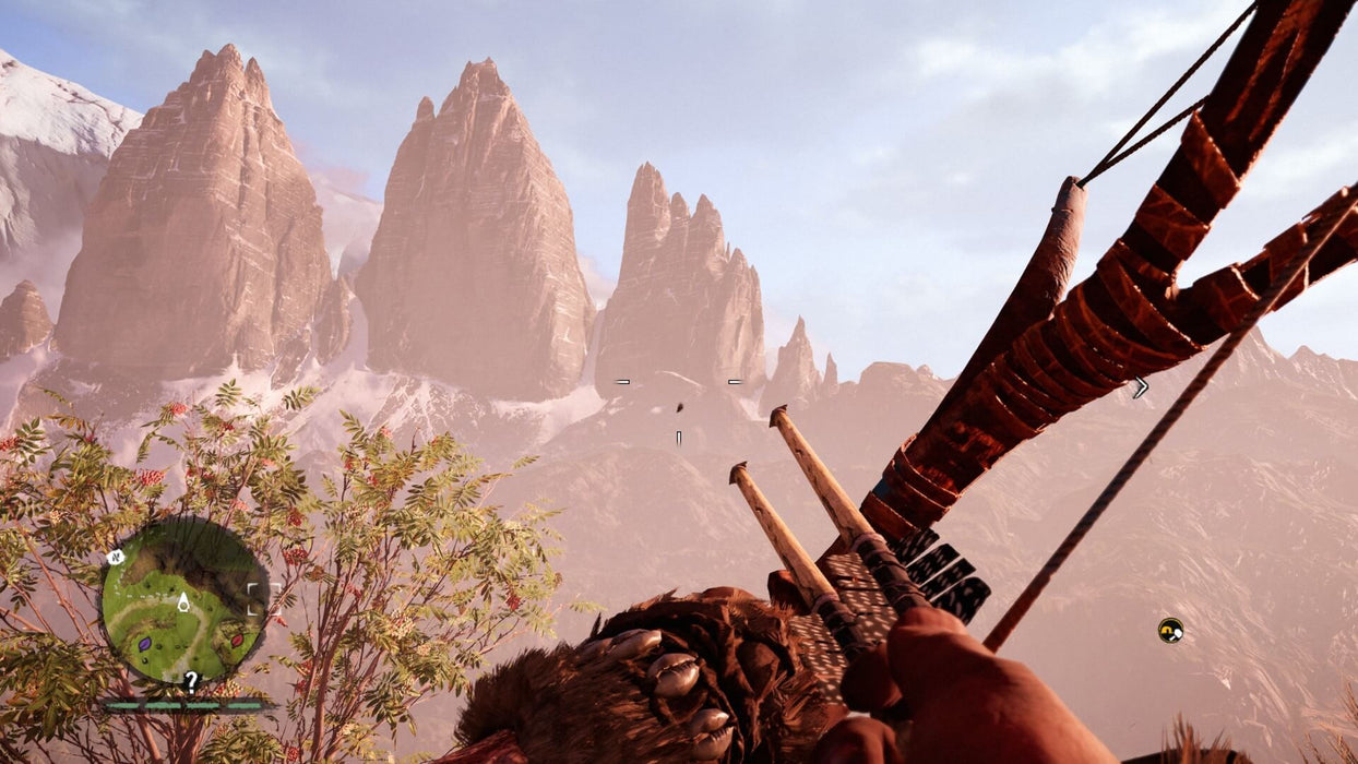 Gameplay screenshot from Far Cry Primal on PC, showcasing a breathtaking prehistoric mountain landscape viewed from a first-person perspective with a crafted bow in hand. Experience the untamed world—buy your Ubisoft Connect key at RushGame.co
