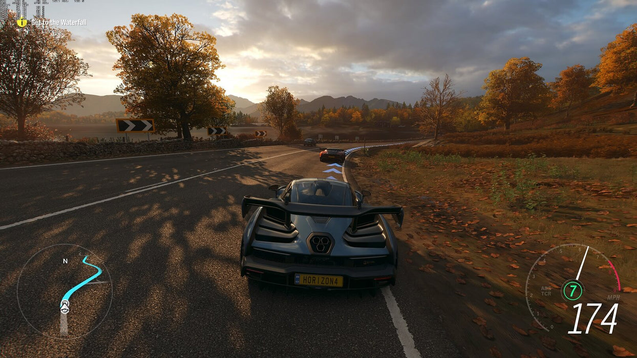 Screenshot from Forza Horizon 4 showing a sleek McLaren supercar racing through an autumn countryside. Experience stunning visuals and high-speed action—get your Forza Horizon 4 CD Key at RushGame.co today