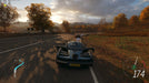 Screenshot from Forza Horizon 4 showing a sleek McLaren supercar racing through an autumn countryside. Experience stunning visuals and high-speed action—get your Forza Horizon 4 CD Key at RushGame.co today