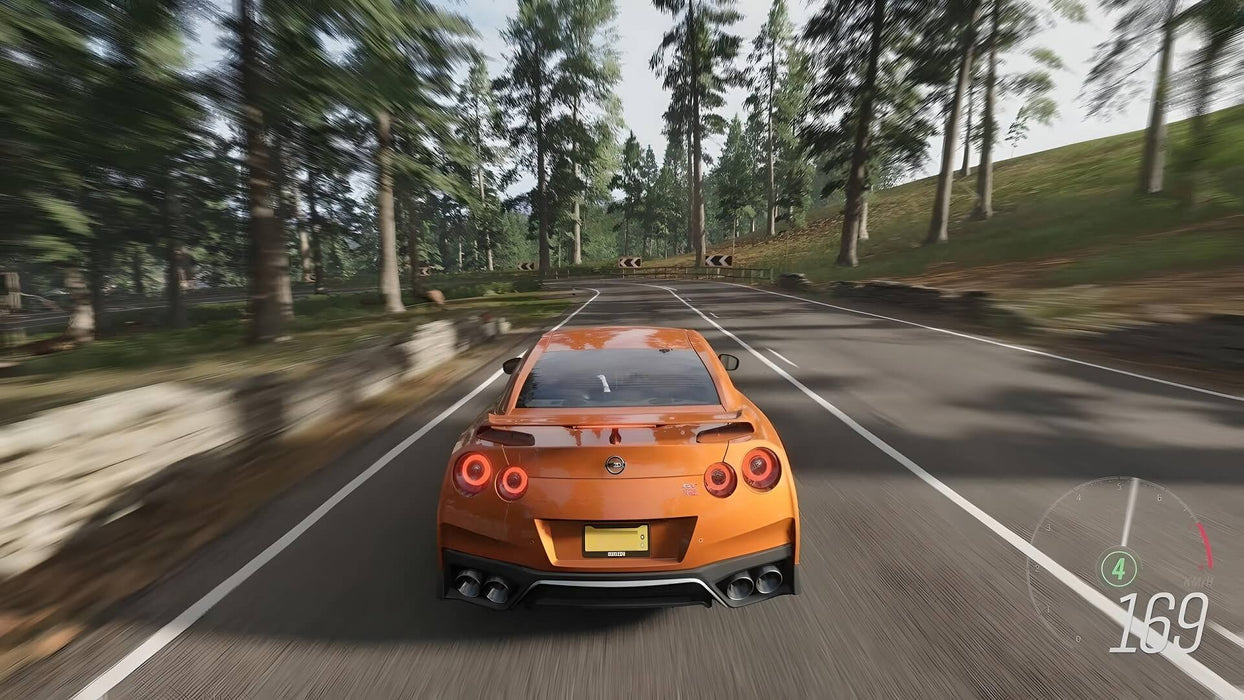 Gameplay image - High-speed racing action in Forza Horizon 4 Ultimate Edition, featuring a Nissan GT-R roaring through a dense forest. Purchase your digital game code at RushGame.co and race across dynamic seasons in stunning 4K visuals