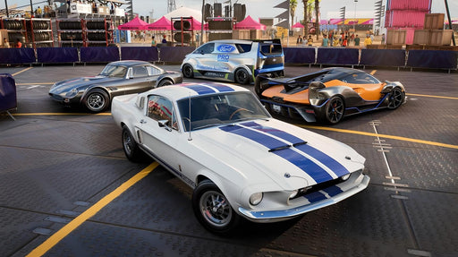 Gameplay screen - A stunning in-game shot from Forza Horizon 5 Car Pass DLC featuring a classic Ford Mustang Shelby GT500 and other high-performance vehicles at the Horizon Festival. Purchase your game key at RushGame.co and race legendary cars across Mexico’s open roads
