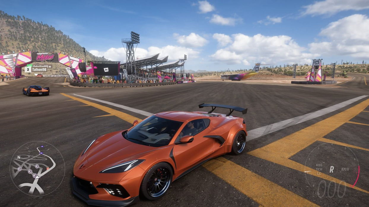 Gameplay screenshot - An orange Chevrolet Corvette C8 parked at the Horizon Festival in Forza Horizon 5 Deluxe Edition, ready to race against top competitors. Buy your digital activation key at RushGame.co and customize high-performance cars in stunning detail