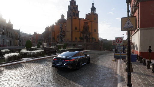 Gameplay screenshot - A black BMW M8 driving through the historic streets of Guanajuato in Forza Horizon 5, with stunning architecture and cobblestone roads. Experience Mexico’s breathtaking landscapes with Forza Horizon 5 Premium Edition—available now at RushGame.co