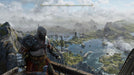 Gameplay screenshot - Kratos stands on a cliffside overlooking a vast, misty Nordic landscape in God of War Ragnarök on PS5. Discover an immersive world of gods and monsters—get your Deluxe Edition CD Key at RushGame.co
